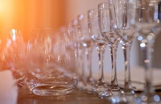 beautiful with the prospect of a row of wine glasses on a wooden table. High quality photo