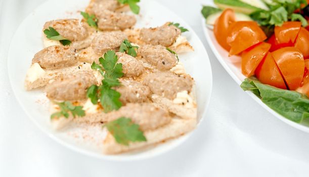 Open sandwiches with meatballs fried meat next to tomatoes . High quality photo