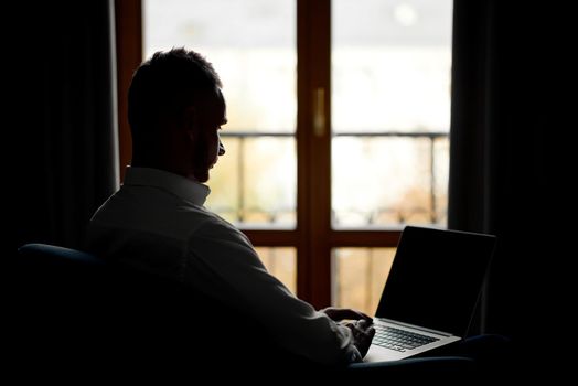 man running remotely from home sitting on a chair. High quality photo