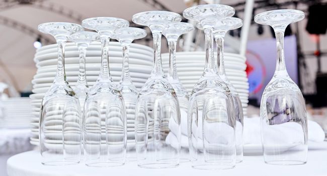 Catering services. closeup Glasses without wine and plates background at outdoor party. High quality photo