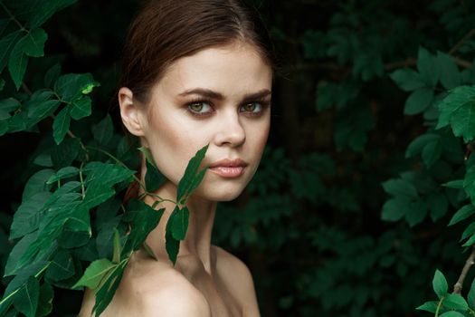 portrait of a woman green leaves clean skin nature summer close-up. High quality photo