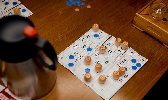 Lotto game in the process with barrels on display on a wooden table. High quality photo