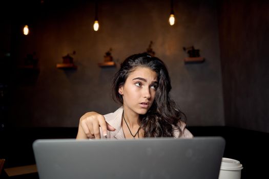 woman in cafe with a cup of drink laptop lifestyle. High quality photo