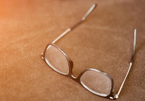 A close up of a pair of glasses on a table. High quality photo