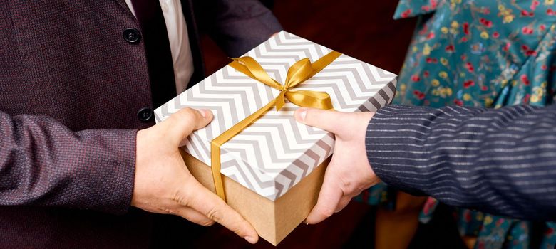 Man giving present box , top view. Holidays, present. Close up hands with gift box on white background. High quality photo