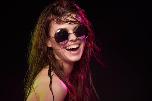 portrait of a woman wearing sunglasses posing luxury dark background. High quality photo