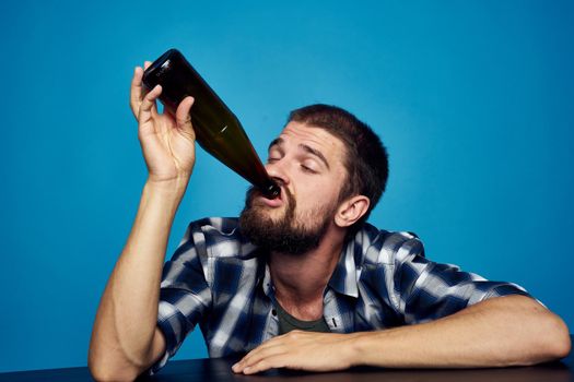 a man in a plaid shirt drinking beer alcohol emotion isolated background. High quality photo