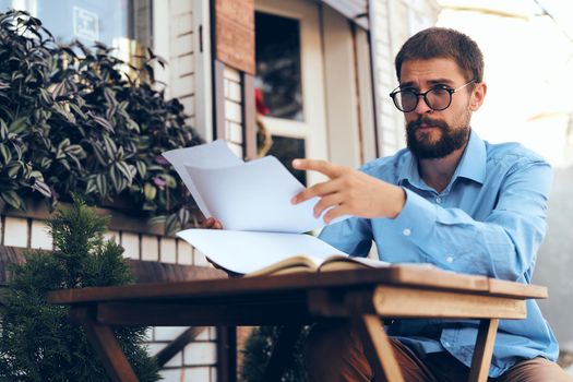 business man in blue shirt in cafe work paperwork. High quality photo