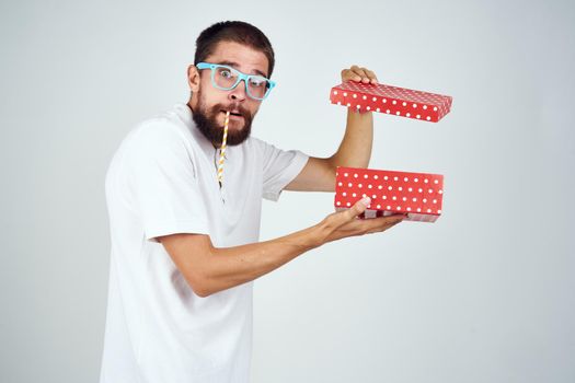 bearded man in a white shirt holding a holiday gift. High quality photo