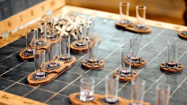 alcoholic board game sea battle with stacks of glass glasses. High quality photo