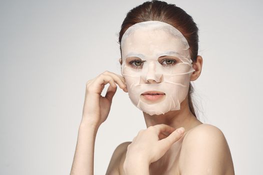 emotional woman cosmetic face mask close-up light background. High quality photo