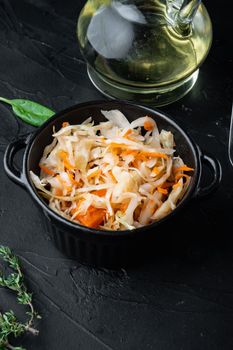 Homemade sauerkraut with cumin set, on black background