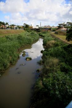 salvador, bahia, brazil - july 20, 2021: view of polluted water channel of sewage network in Rio Camurugipe in the city of Salvador.