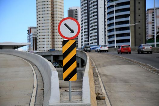 salvador, bahia, brazil - july 20, 2021: Traffic sign indicates mandatory crossing and zebra stripe indicates obstacle and danger marker on a traffic lane in the city of Salvador.