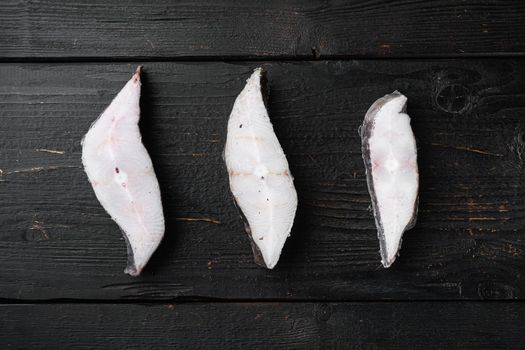 Slices of white fish seafood market set, on black wooden table background, top view flat lay