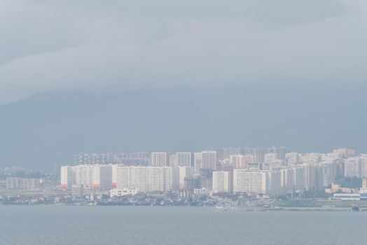 Novorossijsk city view on a foggy summer day, sea and mountains through the fog