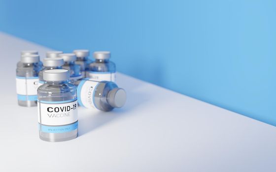 CORONAVIRUS VACCINES ON A WHITE TABLE WITH A BLUE WALL