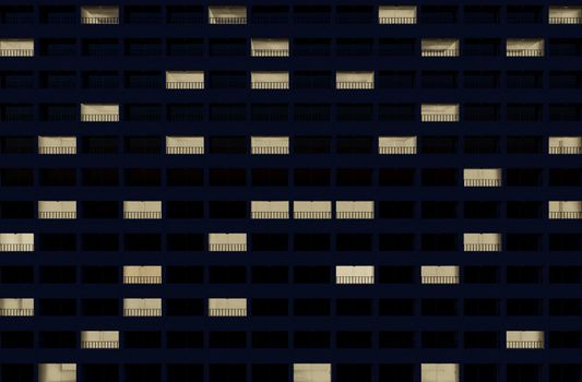 building facade at night with some rooms illuminated. 3d rendering