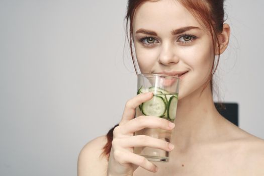 woman with bare shoulders cucumber health drink Fresh. High quality photo