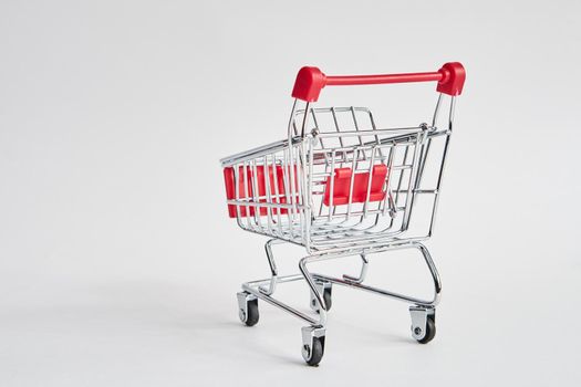 empty trolley on light background shopping supermarket service. High quality photo