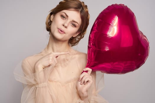 pretty woman red heart in the hands of the balloon isolated background. High quality photo