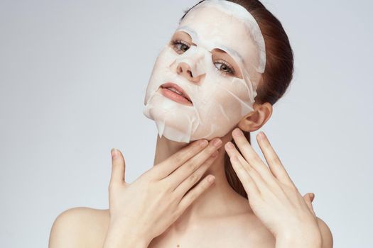 emotional woman cosmetic face mask close-up light background. High quality photo