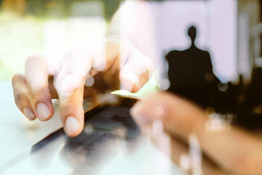 Close up image of a man using mobile smart phone and digital tablet