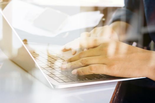 Close up image of Man typing on laptop keyboard