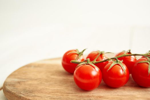 Ingredients Cherry tomatoes on a cutting board wood background. High quality photo
