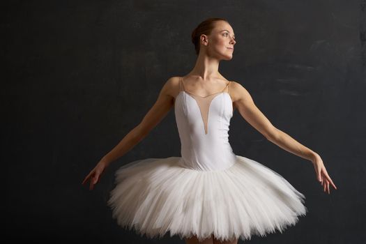 ballerina in a white tutu dance performance silhouette dark background. High quality photo