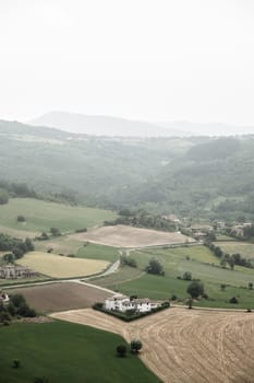 Aerial view of countryside with hills and farm in the small village of " Italian name: Zavattarello Oltrepo Pavese" lombardy