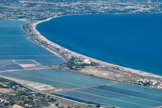 aerial view of (Poetto beach ) seashore of the city of (Cagliari) with salinas field - Sardinia - Italy