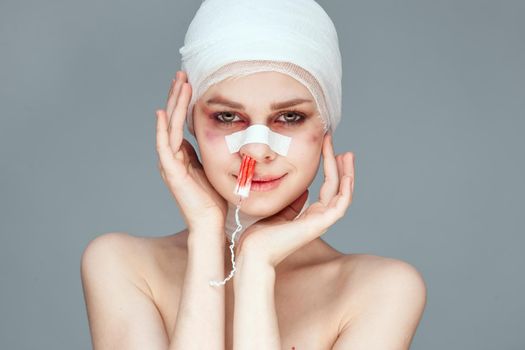 woman tampon in the nose with blood injured face studio lifestyle. High quality photo