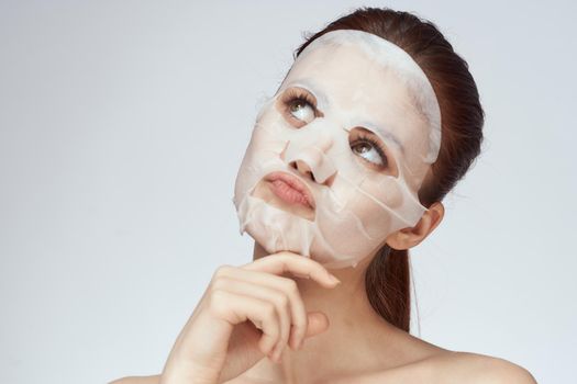pretty woman naked shoulders face mask close-up skin care. High quality photo