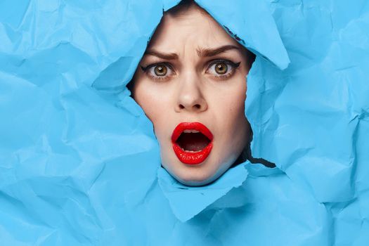 female face blue background red lips makeup emotions. High quality photo