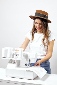 Smiling Girl with sewing machine poses for photo High quality photo