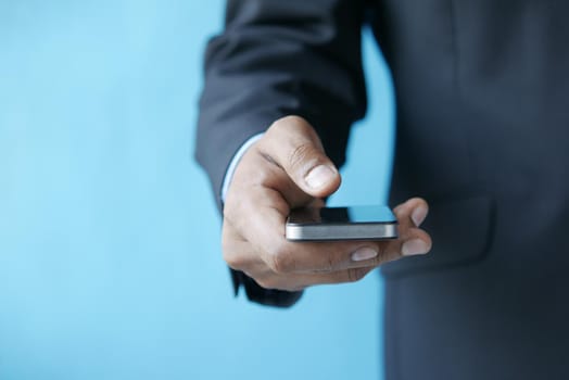 Close up of young man hand using smart phone