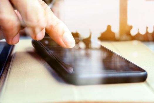 Close up image of a man using mobile smart phone