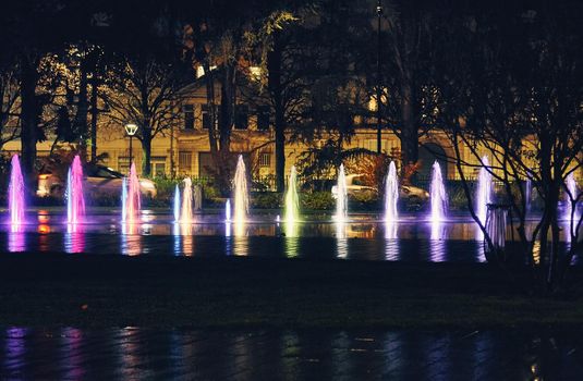 Nantes - a square with fountain and colorful splash rays light at night - France