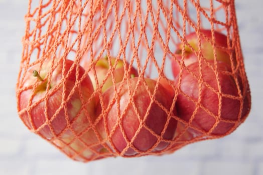 Close up of fresh apple in a shopping bag .