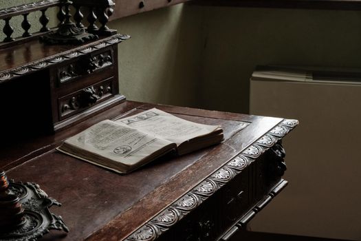 Medieval fortress Cabinet with writing desk with a book and wooden brown chair - interior furniture