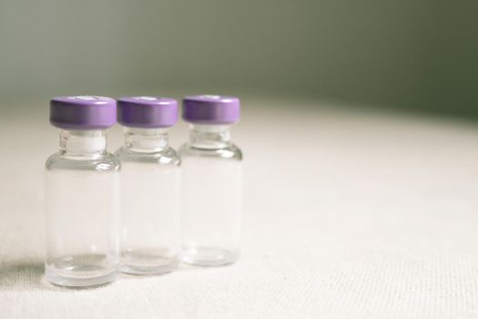 Empty glass jars of coronavirus vaccines. No people