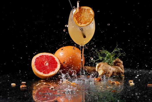 cocktails with grefruth and ginger on a wet table with sprays . High quality photo