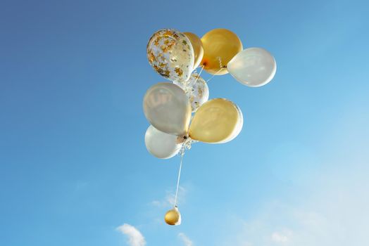 yellow white transparent balloons blue sky 