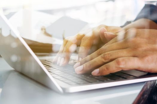 Close up image of Man typing on laptop keyboard