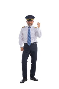 Airline pilot, aircraft commander holding fist showing yes gesture isolated on white background full length studio portrait