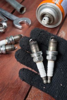 used spark plug with soot in technician hand