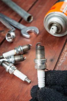 used spark plug with soot in technician hand