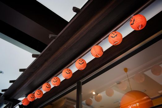 asian style of orange lanterns with halloween face