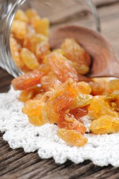 closeup heap of delicious raisins on wooden table